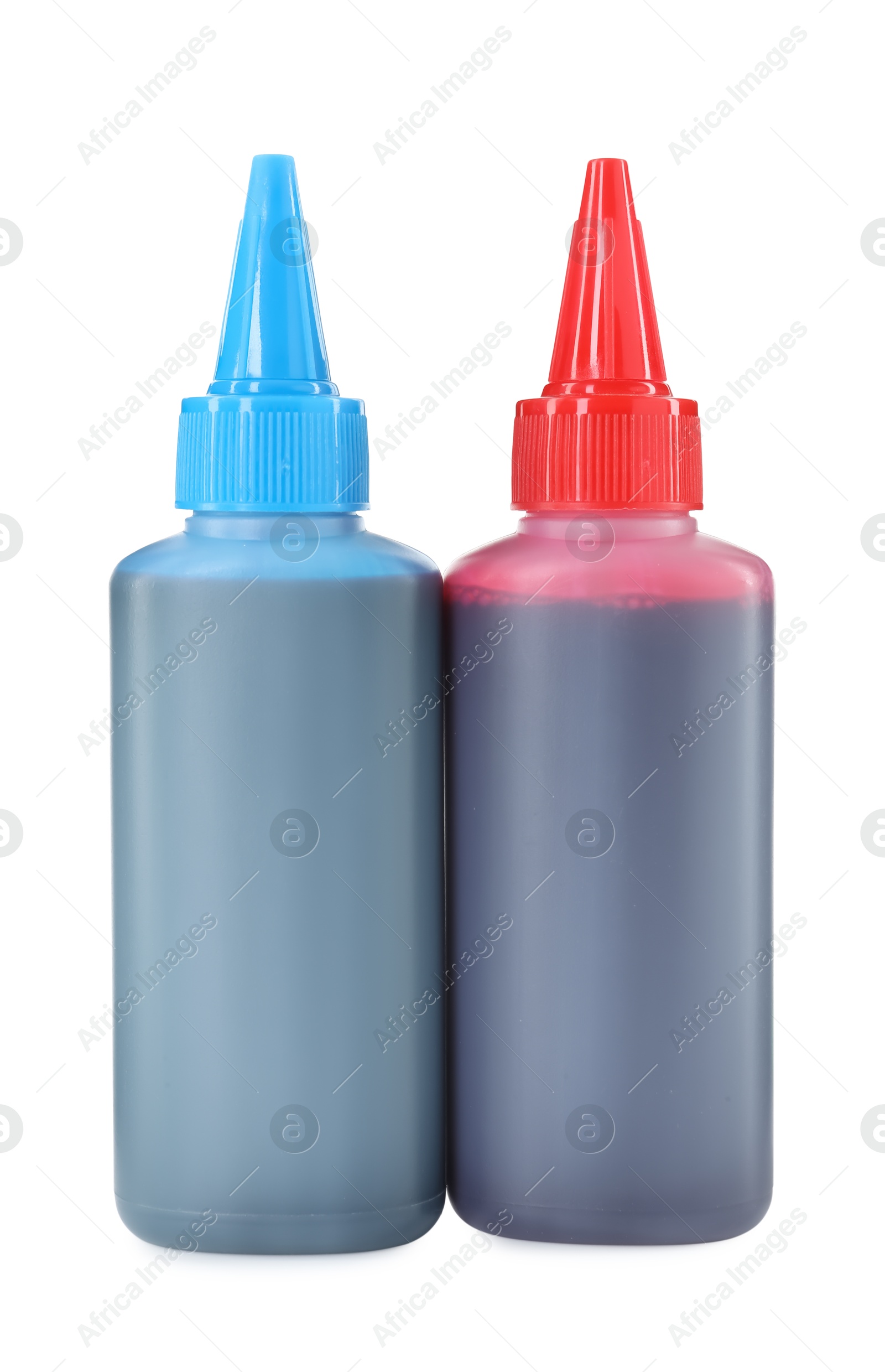 Photo of Bottles of different printer ink isolated on white