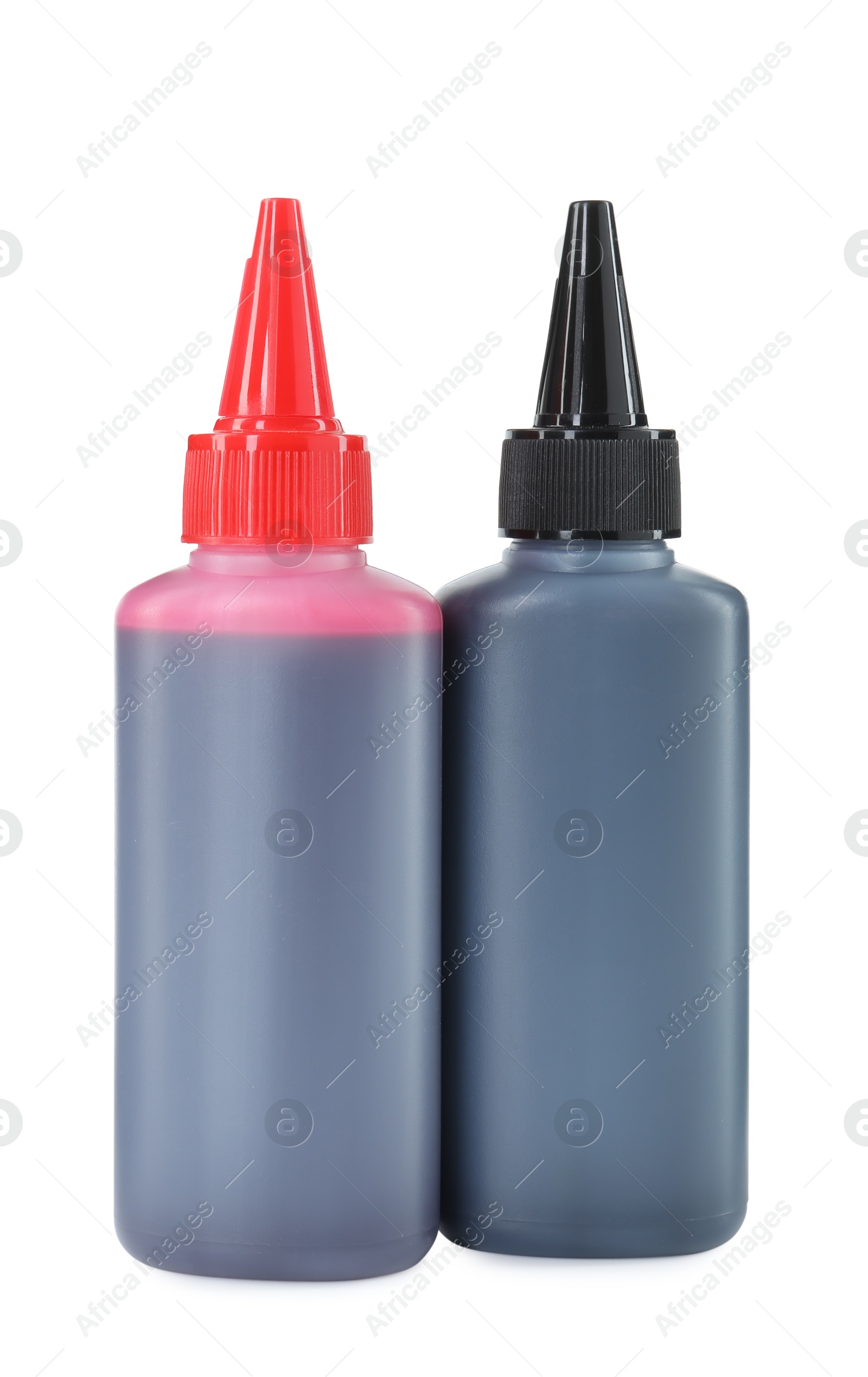 Photo of Bottles of different printer ink isolated on white