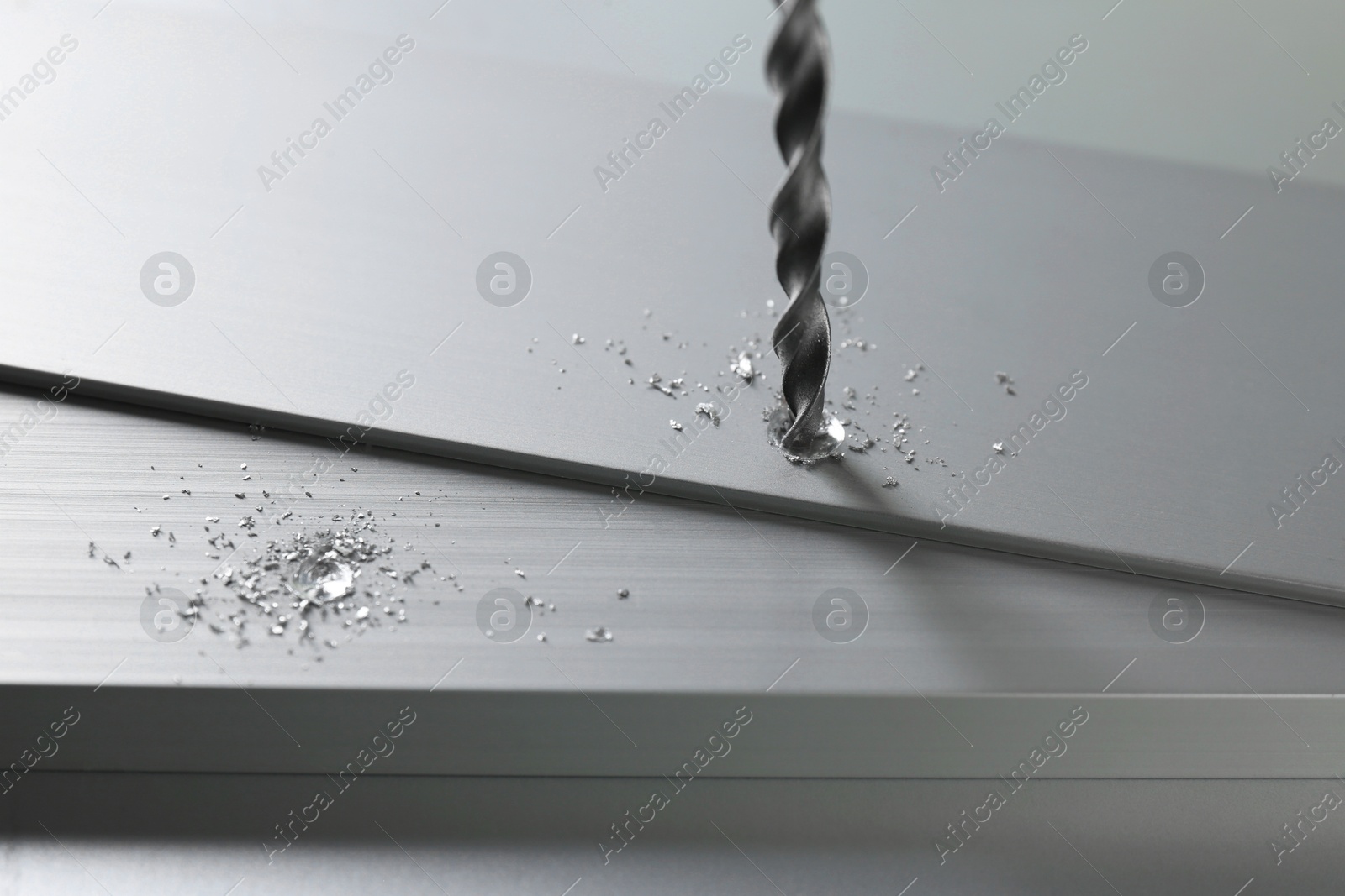 Photo of Drilling hole in plank on light table, closeup