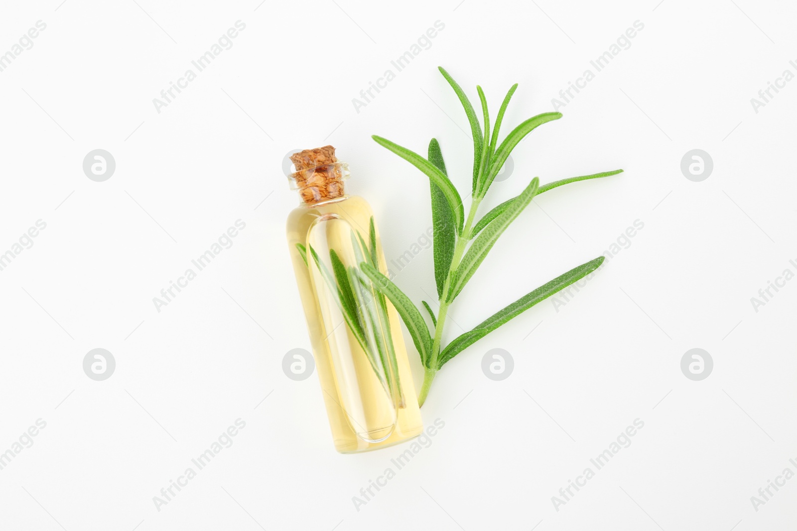 Photo of Aromatic essential oil in bottle and rosemary on white background, top view