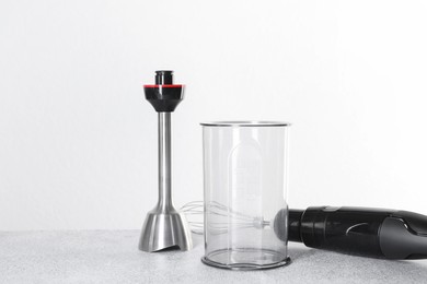 Photo of Hand blender kit on gray table against white background, space for text