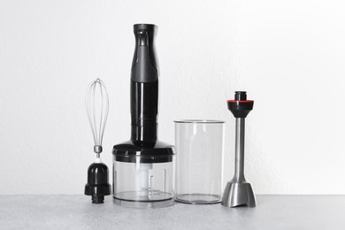 Photo of Hand blender kit on gray table against white background