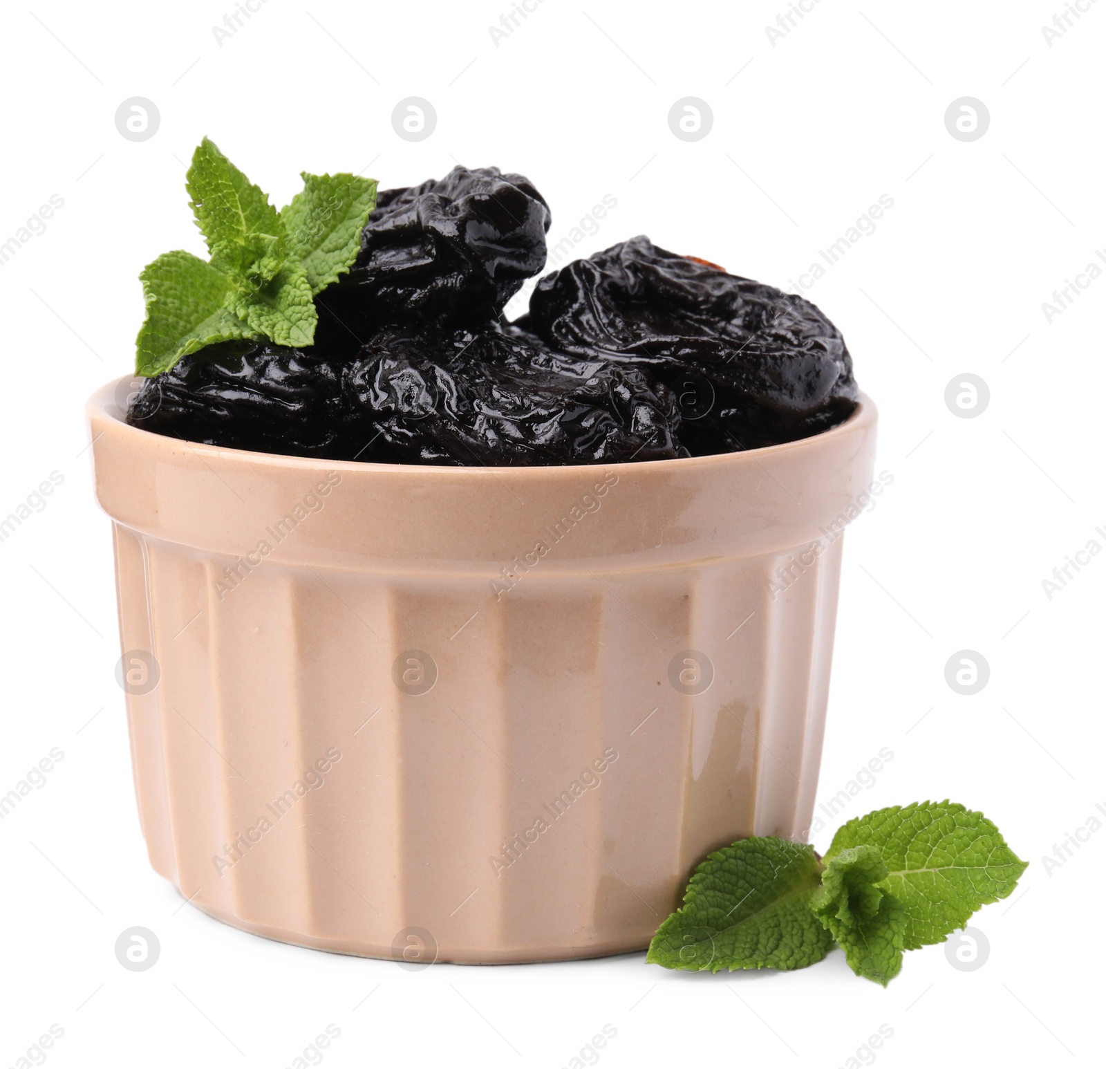 Photo of Tasty dried plums (prunes) and mint leaves in bowl on white background