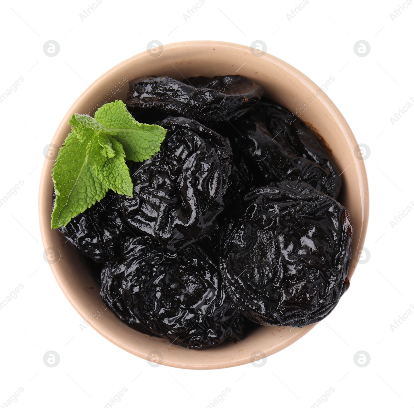 Photo of Tasty dried plums (prunes) and mint leaves in bowl on white background, top view