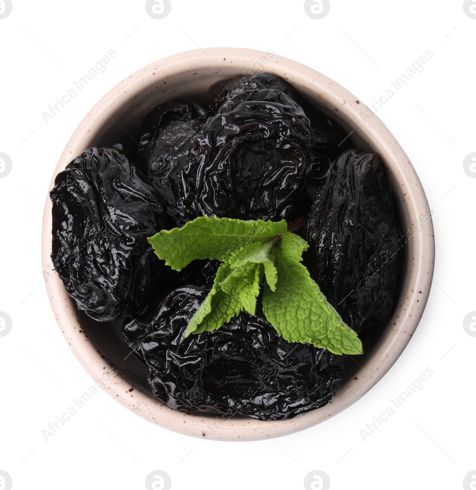 Photo of Tasty dried plums (prunes) and mint leaves in bowl on white background, top view