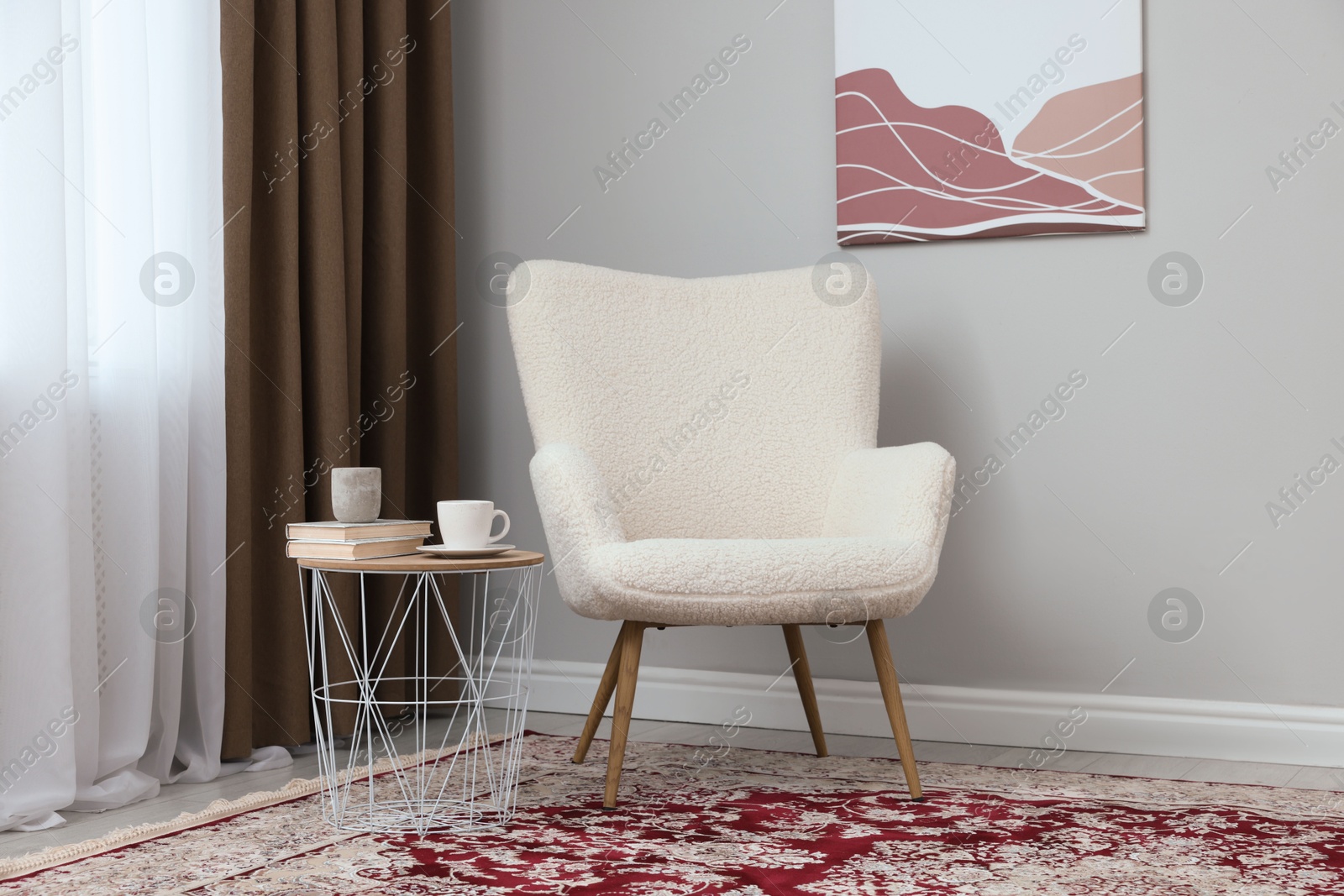 Photo of Soft armchair, side table and window with curtains indoors. Interior design