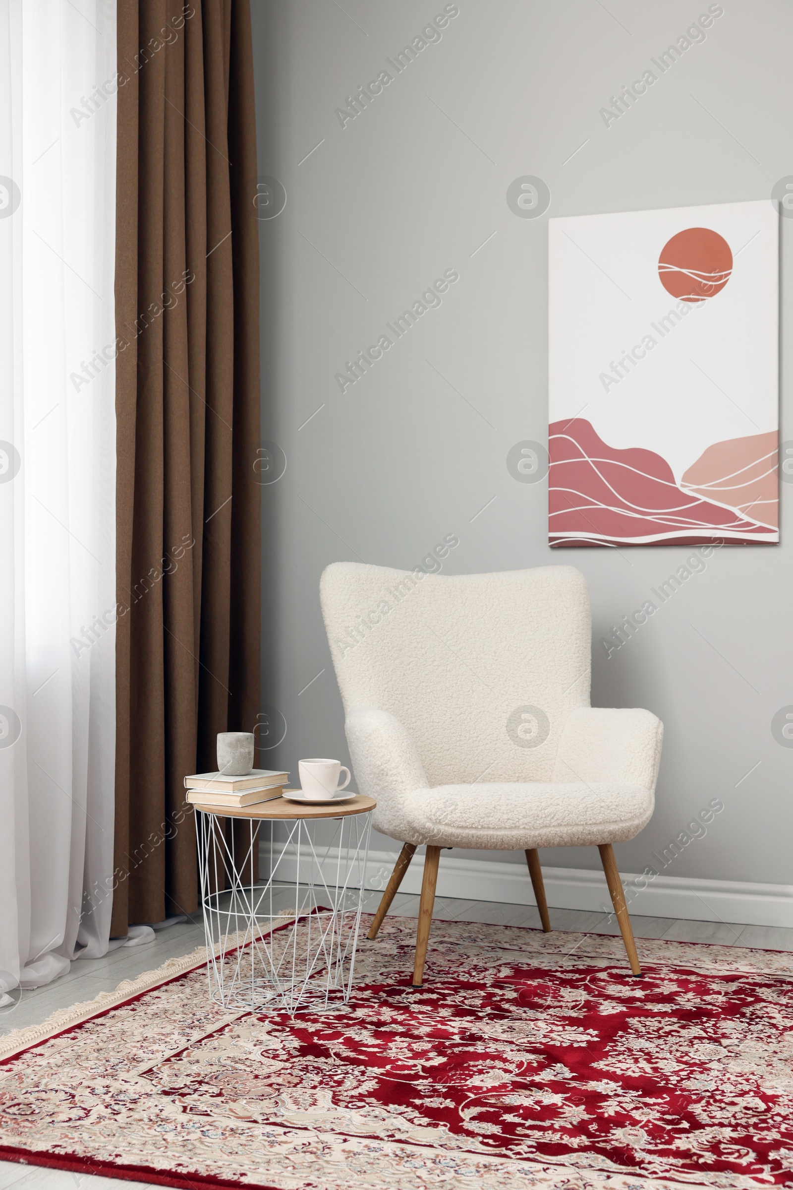 Photo of Soft armchair, side table and window with curtains indoors. Interior design