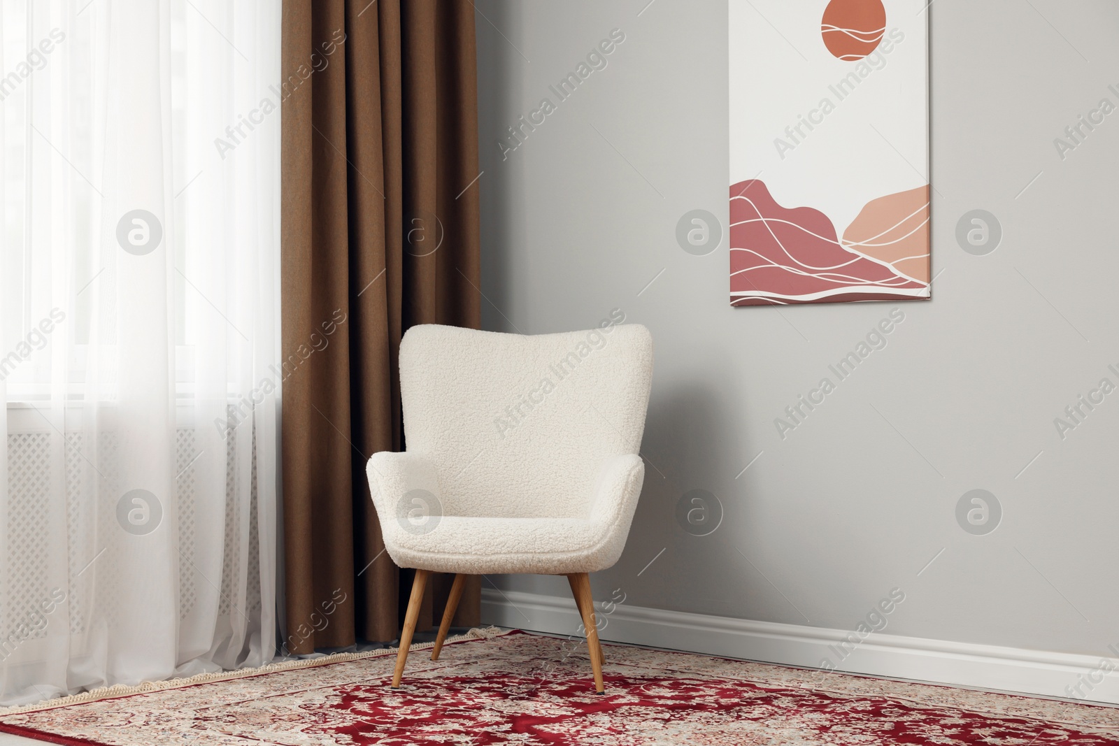 Photo of Soft armchair near window with curtains indoors. Interior design