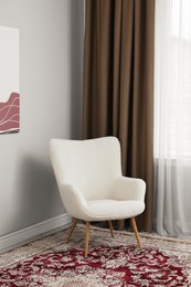 Soft armchair near window with curtains indoors. Interior design