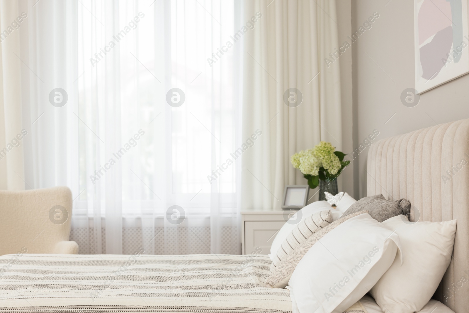 Photo of Large bed and window with curtains in bedroom, space for text. Interior design