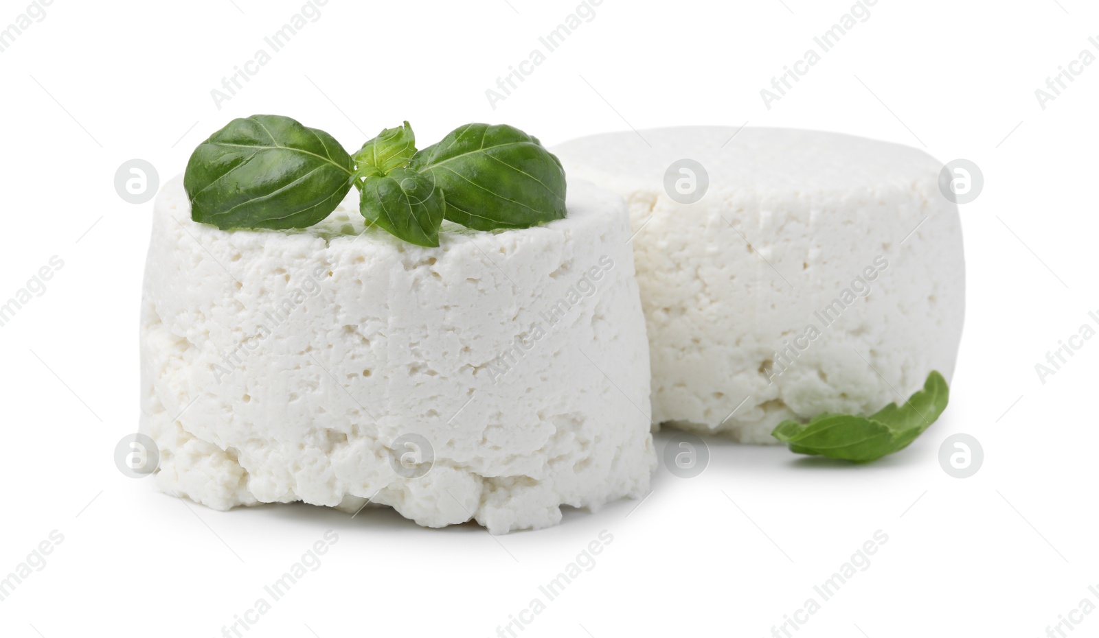 Photo of Fresh ricotta (cream cheese) and basil isolated on white