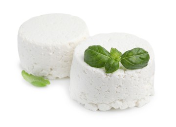 Fresh ricotta (cream cheese) and basil isolated on white