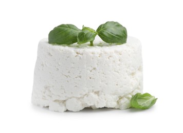 Photo of Fresh ricotta (cream cheese) and basil isolated on white