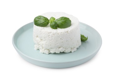 Photo of Fresh ricotta (cream cheese) and basil isolated on white