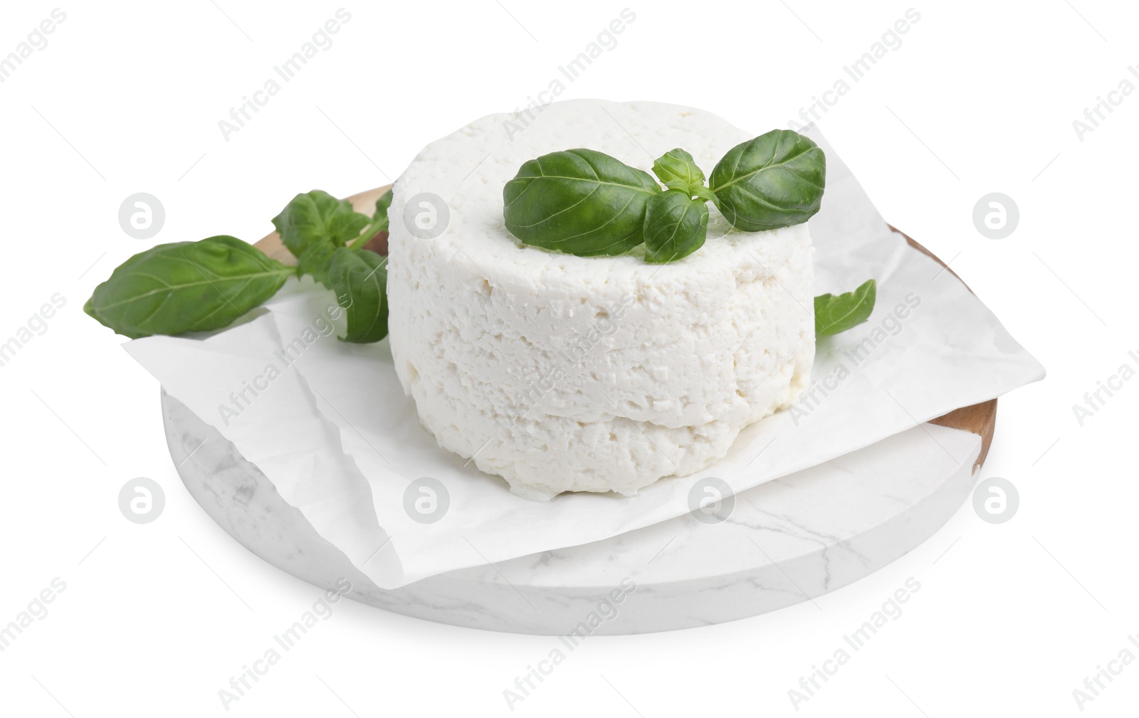 Photo of Fresh ricotta (cream cheese) and basil isolated on white