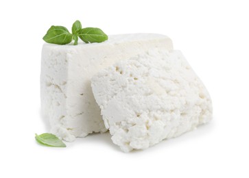 Photo of Fresh ricotta (cream cheese) and basil isolated on white