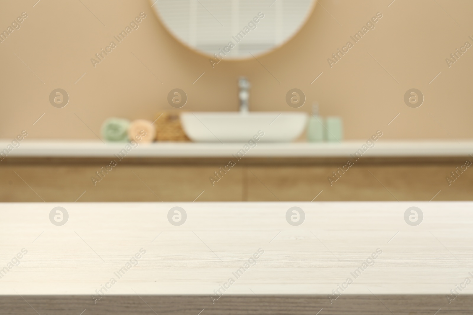 Photo of Empty wooden table in bathroom. Space for design