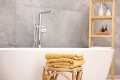 Photo of Stack of clean towels on table in bathroom