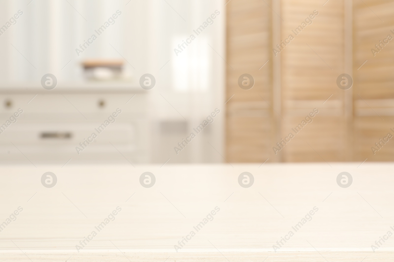 Photo of Empty wooden table in living room, selective focus