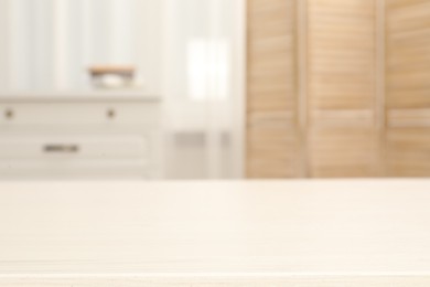 Photo of Empty wooden table in living room, selective focus