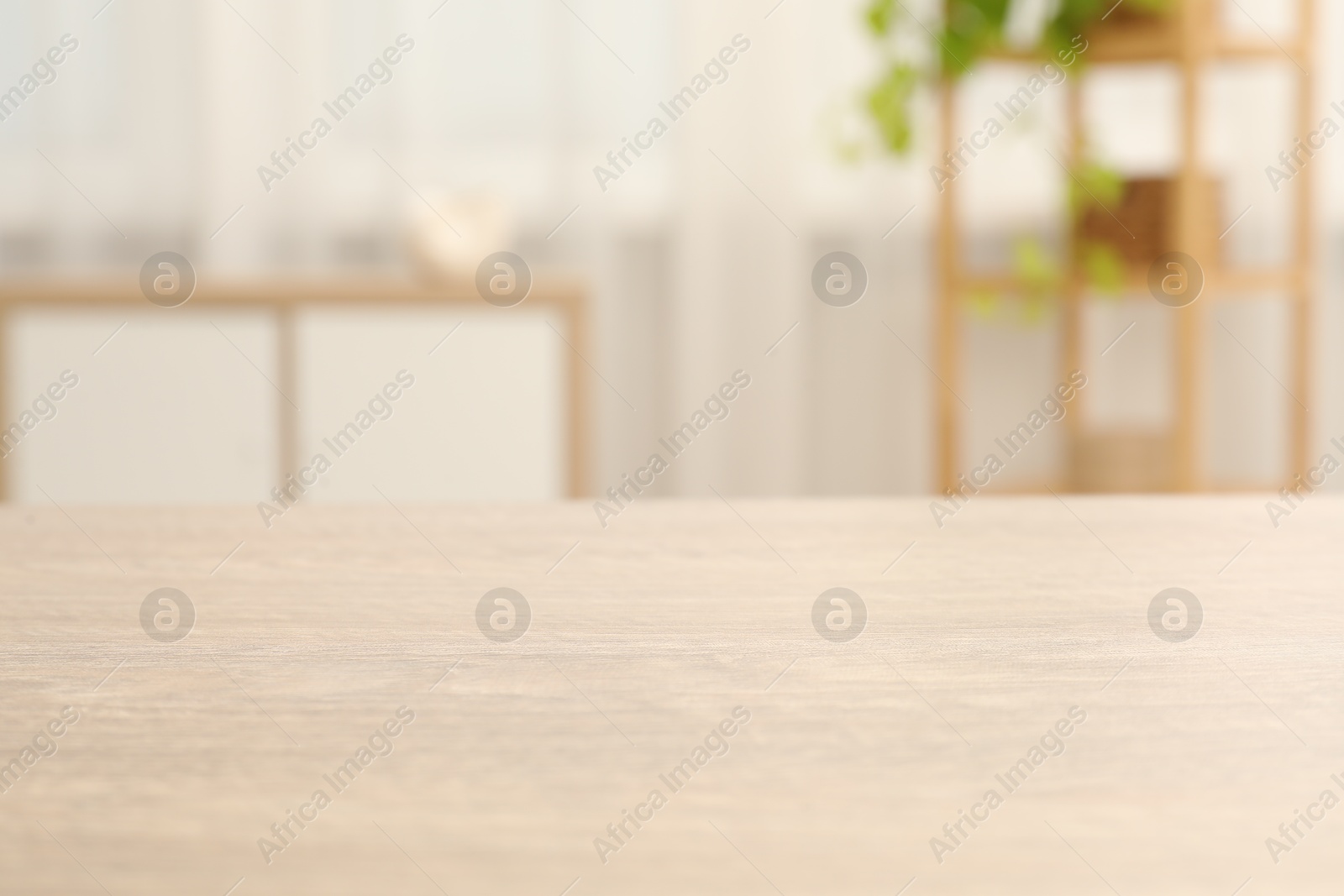 Photo of Empty wooden table in living room, selective focus