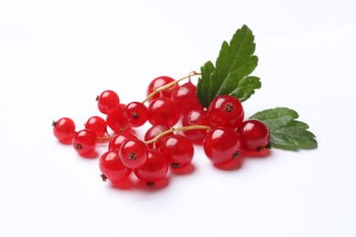 Photo of Fresh ripe red currant berries with green leaves isolated on white