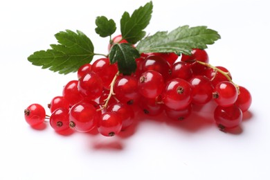 Photo of Fresh ripe red currant berries with green leaves isolated on white