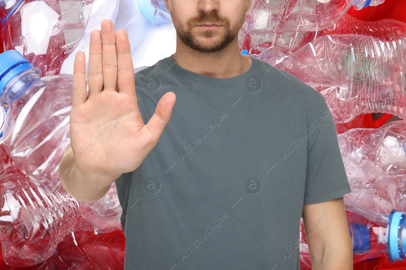 Image of Environmental pollution. Man showing stop gesture, closeup. Garbage on background