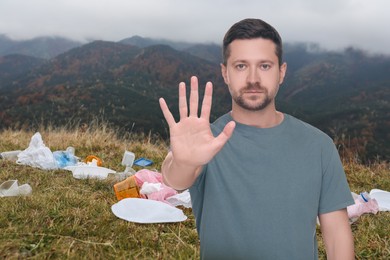 Image of Environmental pollution. Man showing stop gesture among garbage on mountain hill