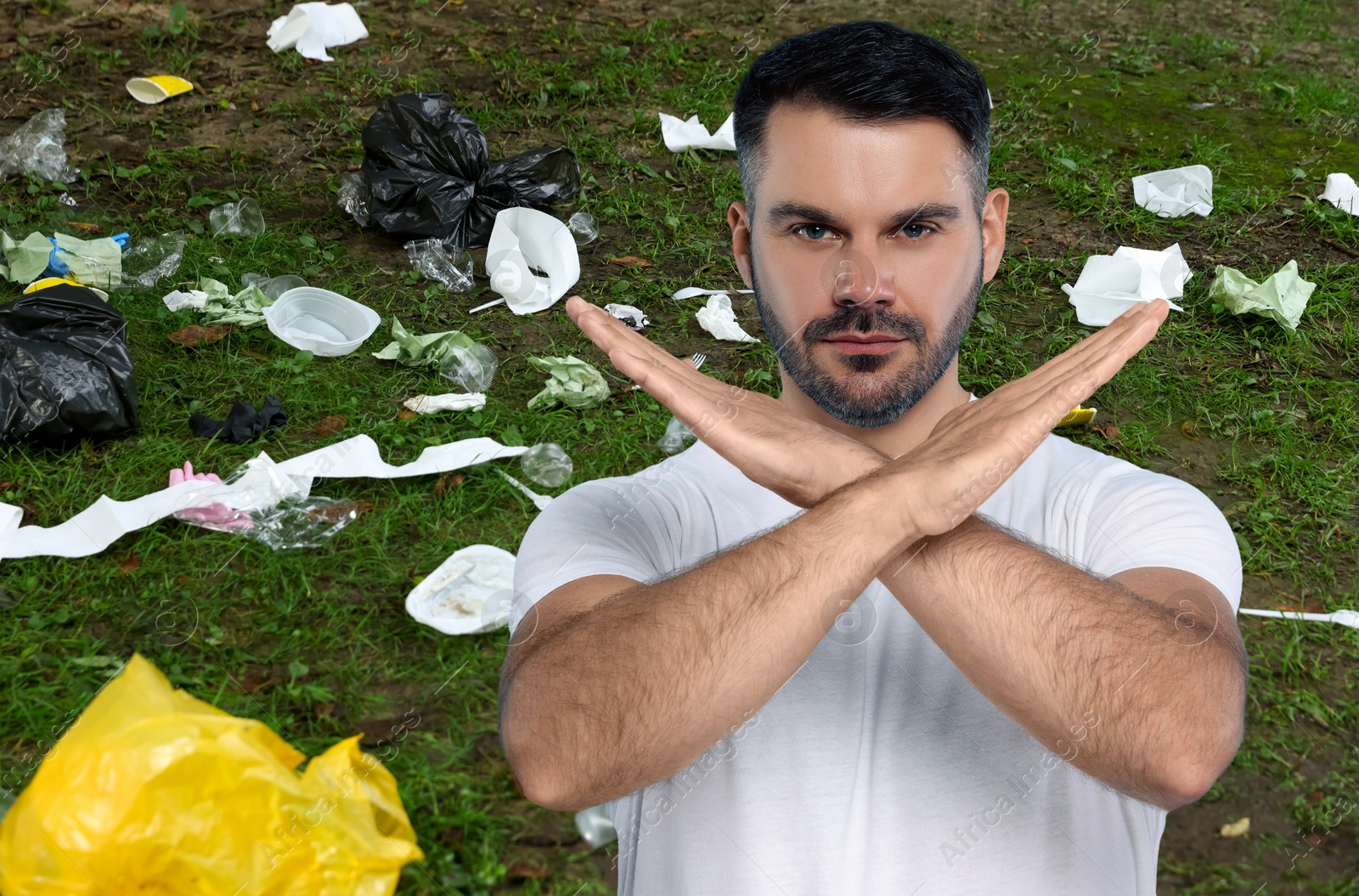 Image of Environmental pollution. Man showing stop gesture among garbage on green grass