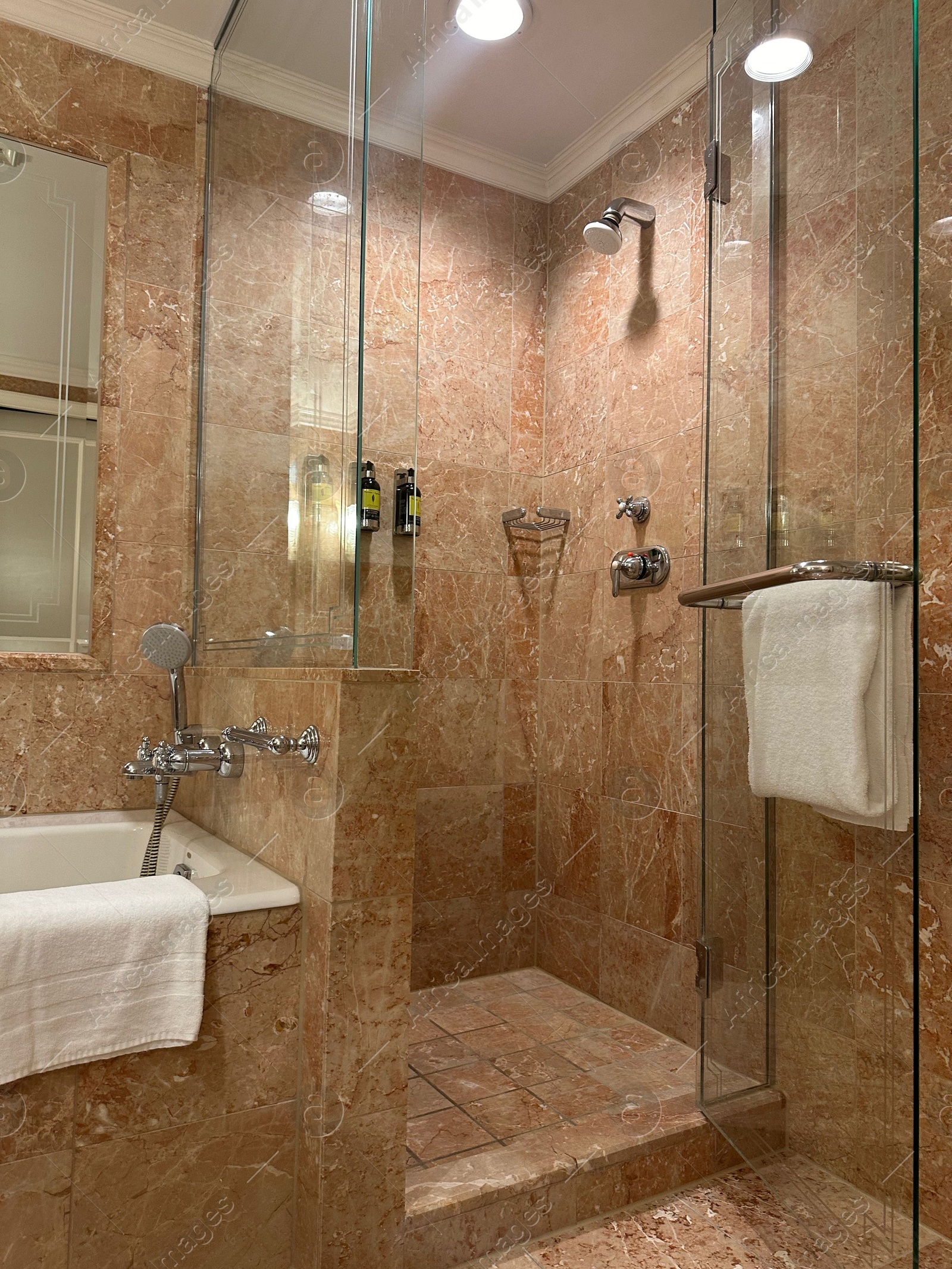 Photo of Luxury hotel interior. Stylish bathroom with mirror and terry towels