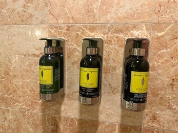 Berlin, Germany - July 2, 2024: Bottles with body care products on tiled wall in Regent Berlin Hotel bathroom