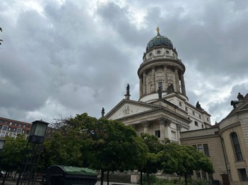 Berlin, Germany - July 2, 2024: Beautiful view of city street with French Church of Friedrichstadt