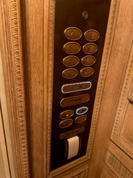 Photo of Elevator with golden buttons in luxury hotel