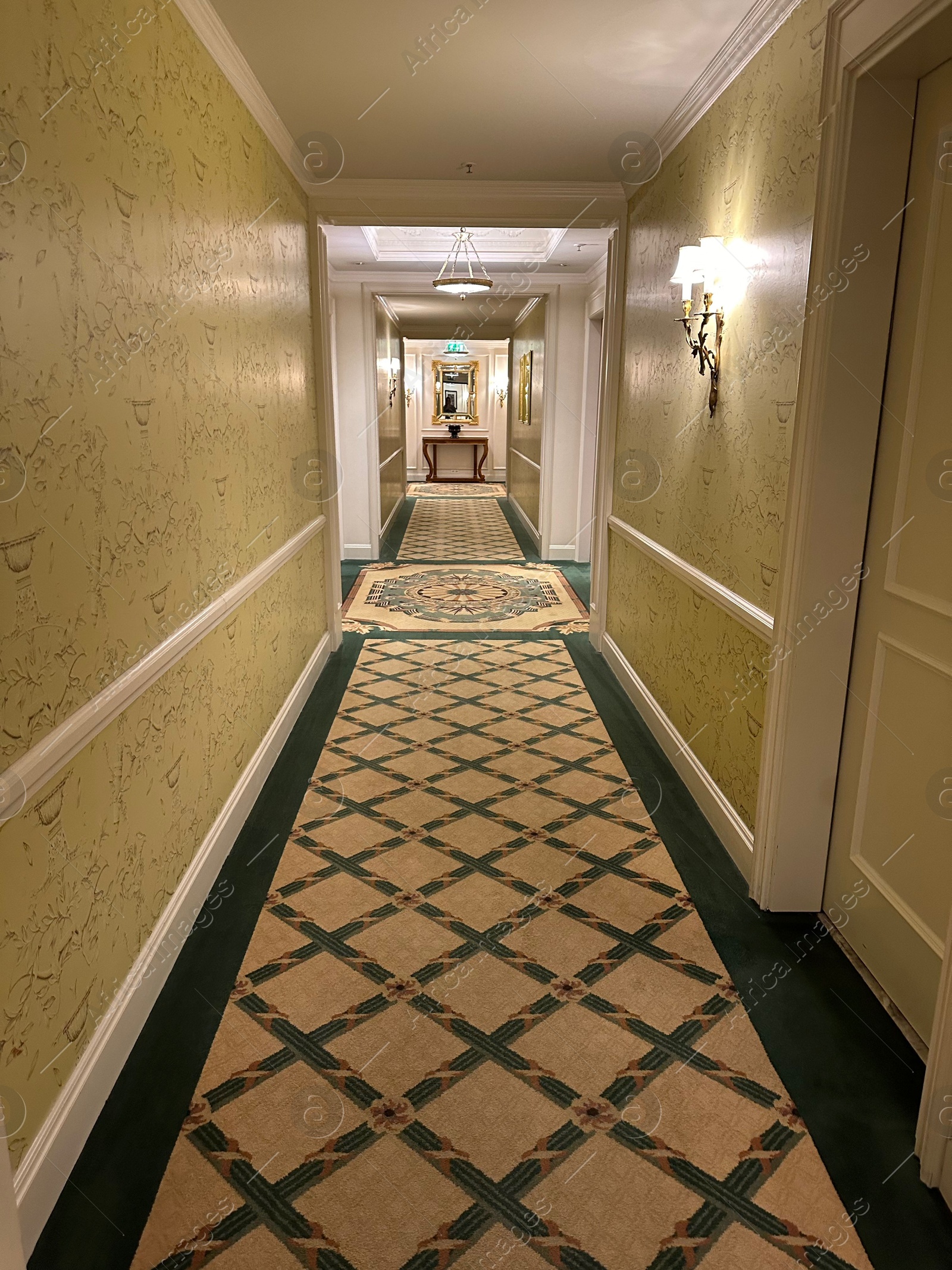 Photo of Luxury hotel interior. Empty long corridor with carpet