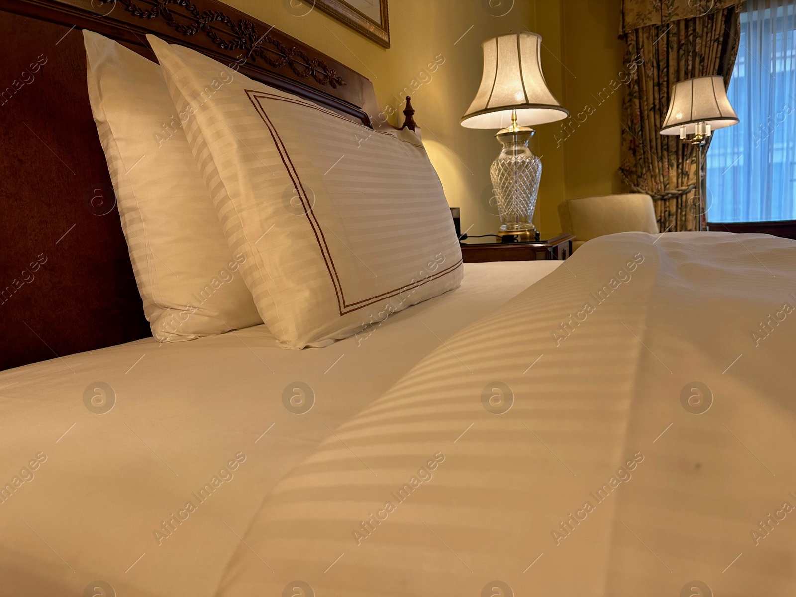 Photo of Comfortable large bed with luxury bedding in hotel room