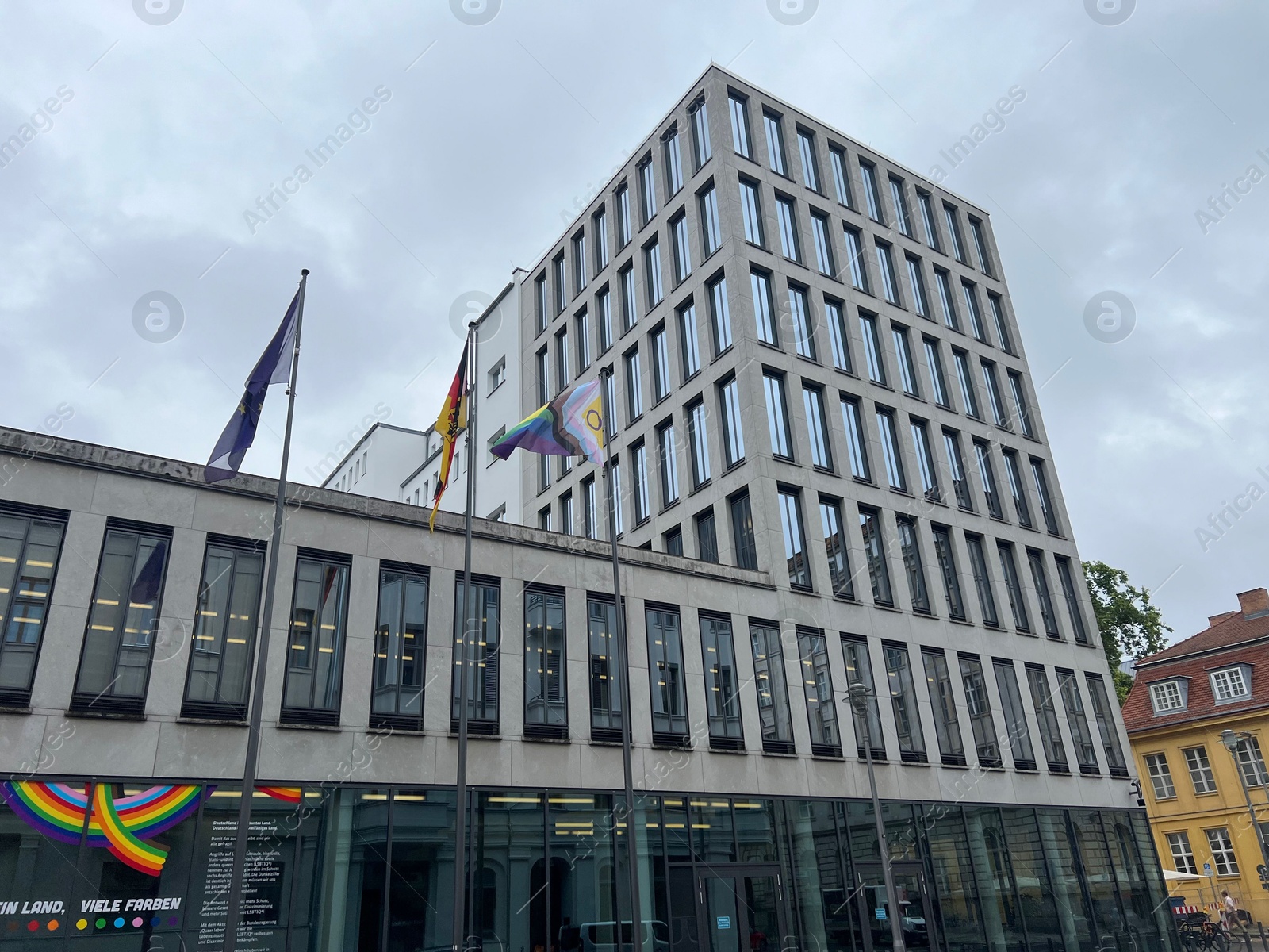 Photo of Berlin, Germany - July 2, 2024: Building with flags of bright progress and Germany outdoors