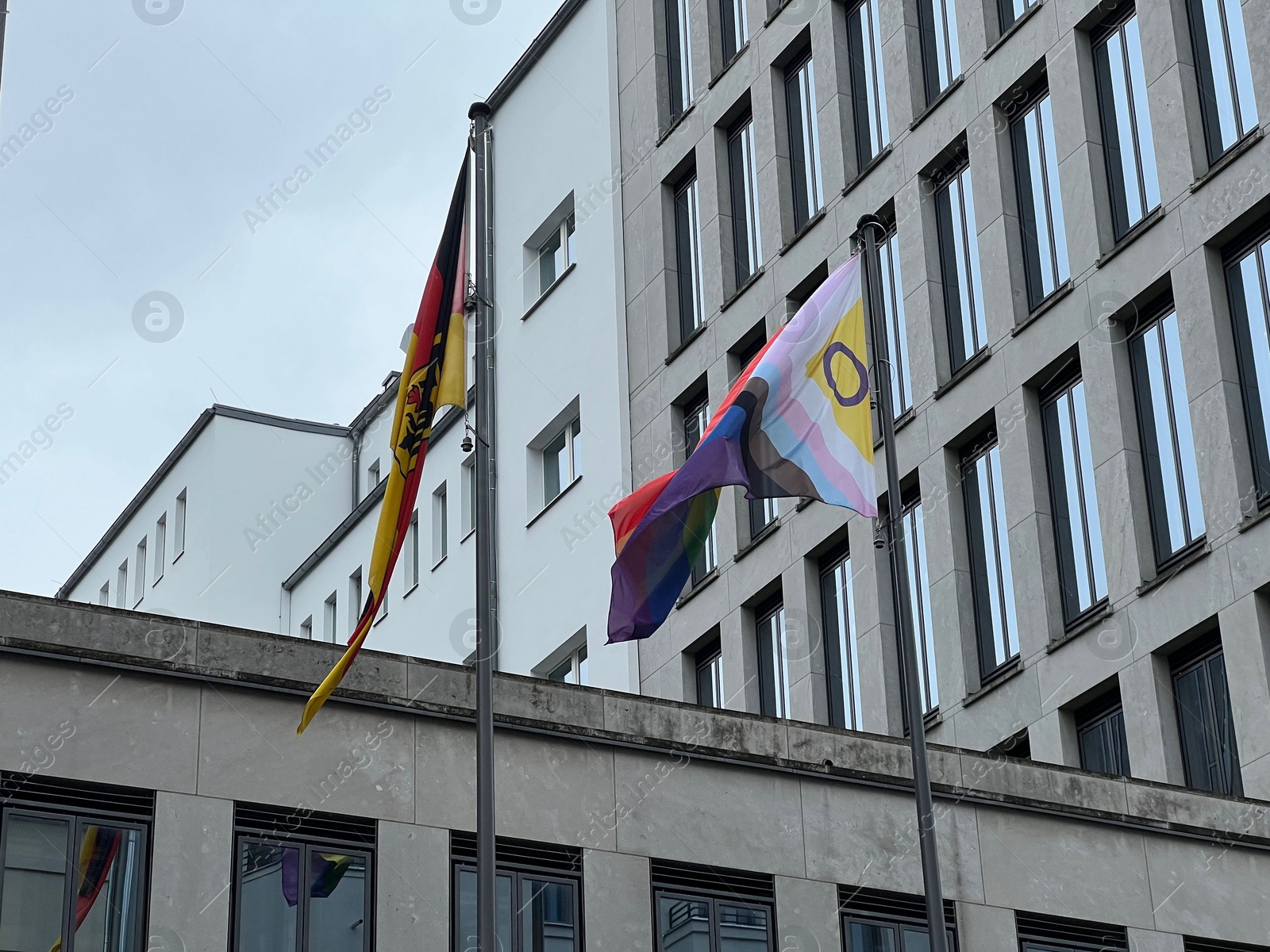 Photo of Berlin, Germany - July 2, 2024: Building with flags of bright progress and Germany outdoors