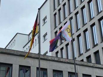 Photo of Berlin, Germany - July 2, 2024: Building with flags of bright progress and Germany outdoors