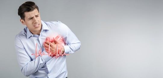 Image of Heart attack. Man writhing in pain and pressing hands to chest on grey background. Banner design with space for text