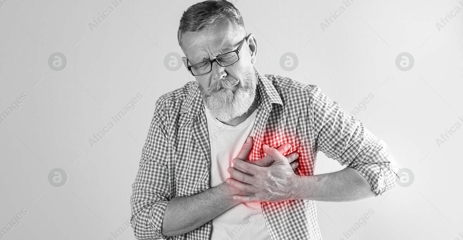 Image of Heart attack. Senior man suffering from severe pain and pressing hands to chest on light background. Banner design