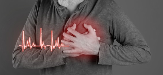 Heart attack. Man suffering from severe pain and pressing hands to chest on grey background, closeup. Banner design