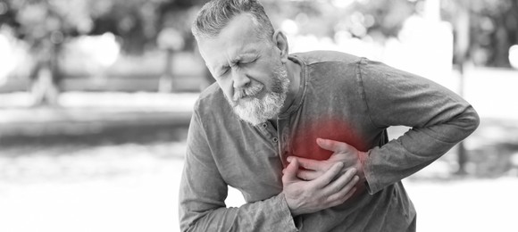 Image of Heart attack. Mature man writhing in pain and pressing hands to chest outdoors. Banner design with space for text
