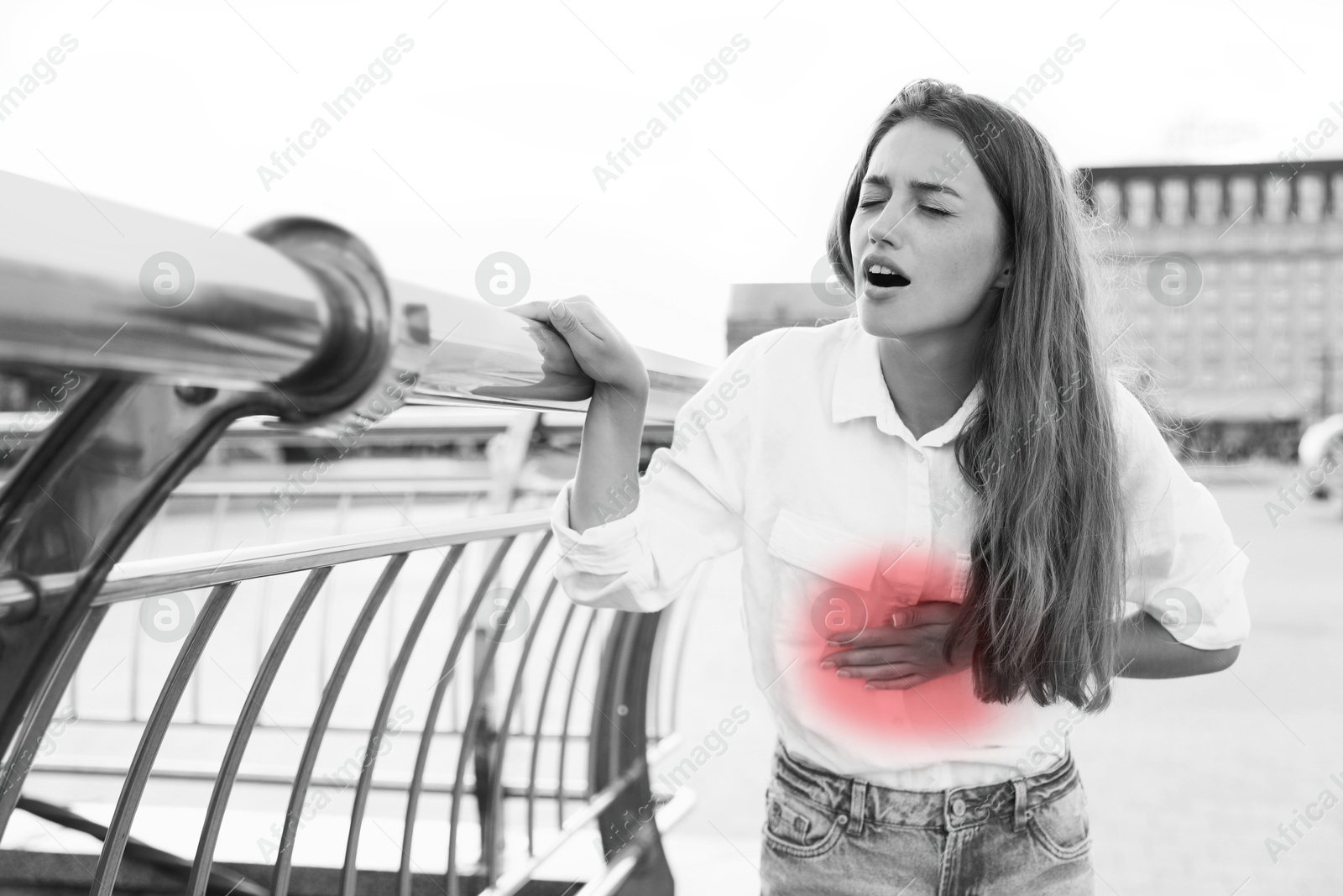 Image of Heart attack. Woman suffering from severe pain in chest outdoors