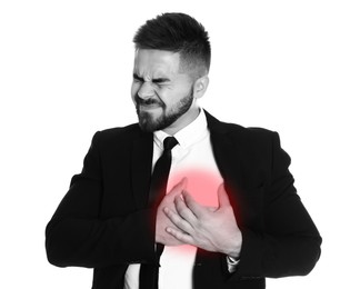 Image of Heart attack. Businessman writhing in pain and pressing hands to chest on white background