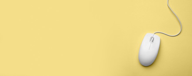 Image of Computer mouse on yellow background, top view. Banner design with space for text