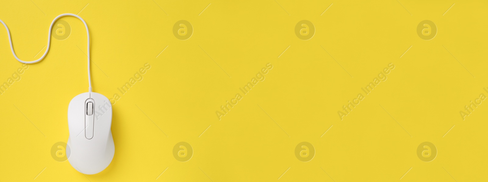 Image of Computer mouse on yellow background, top view. Banner design with space for text