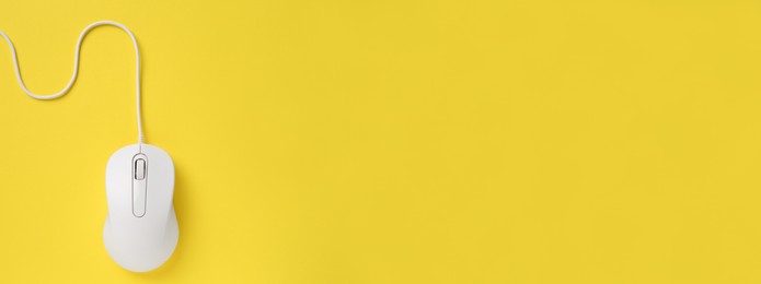 Computer mouse on yellow background, top view. Banner design with space for text