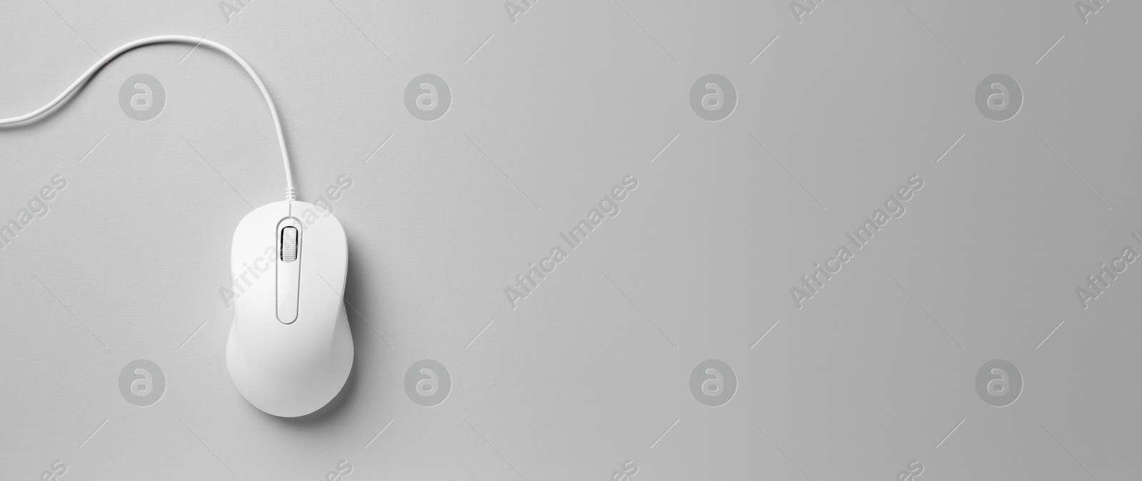 Image of Computer mouse on light grey background, top view. Banner design with space for text