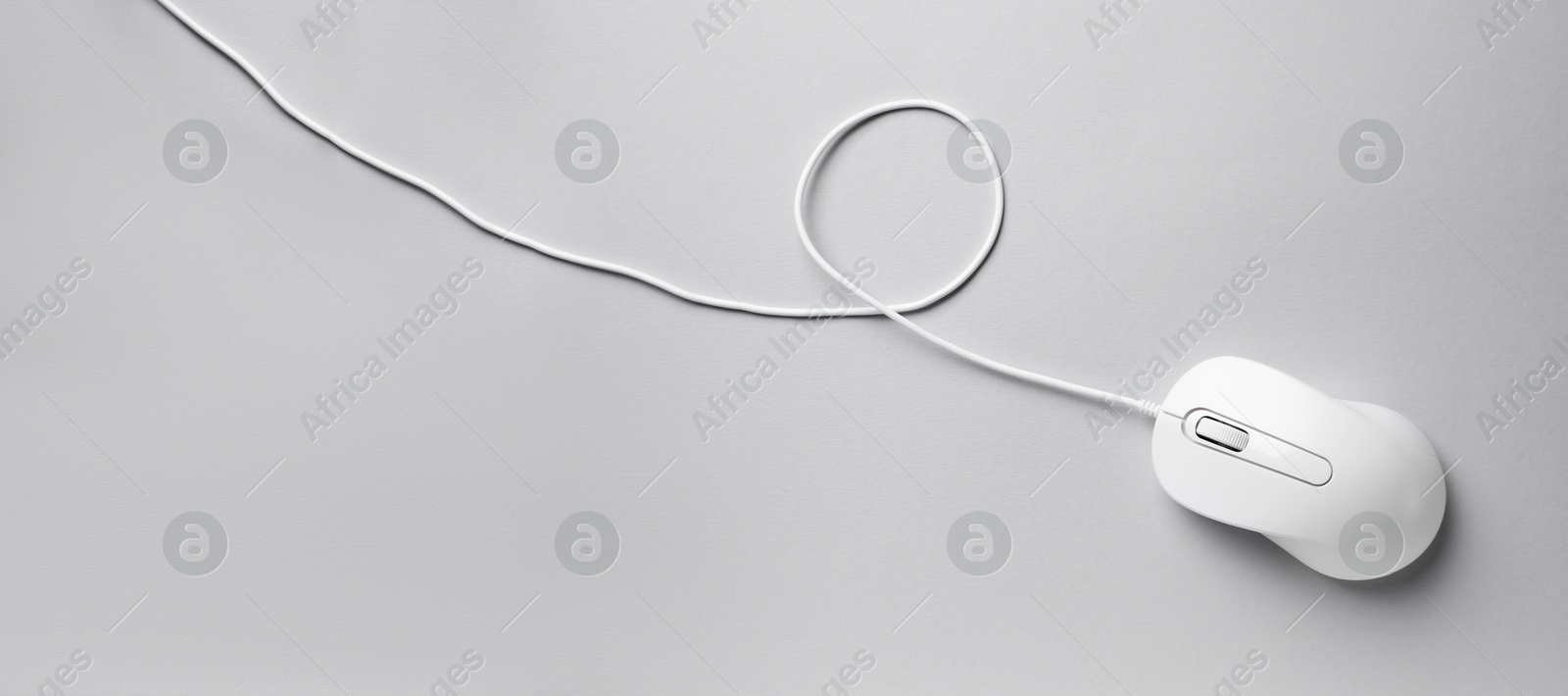 Image of Computer mouse on light grey background, top view. Banner design with space for text